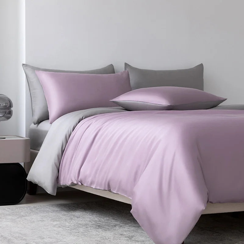 Soléa Bamboo Bedding Set styled on a bed in soft lilac with grey pillowcases, sateen sheen catching the light