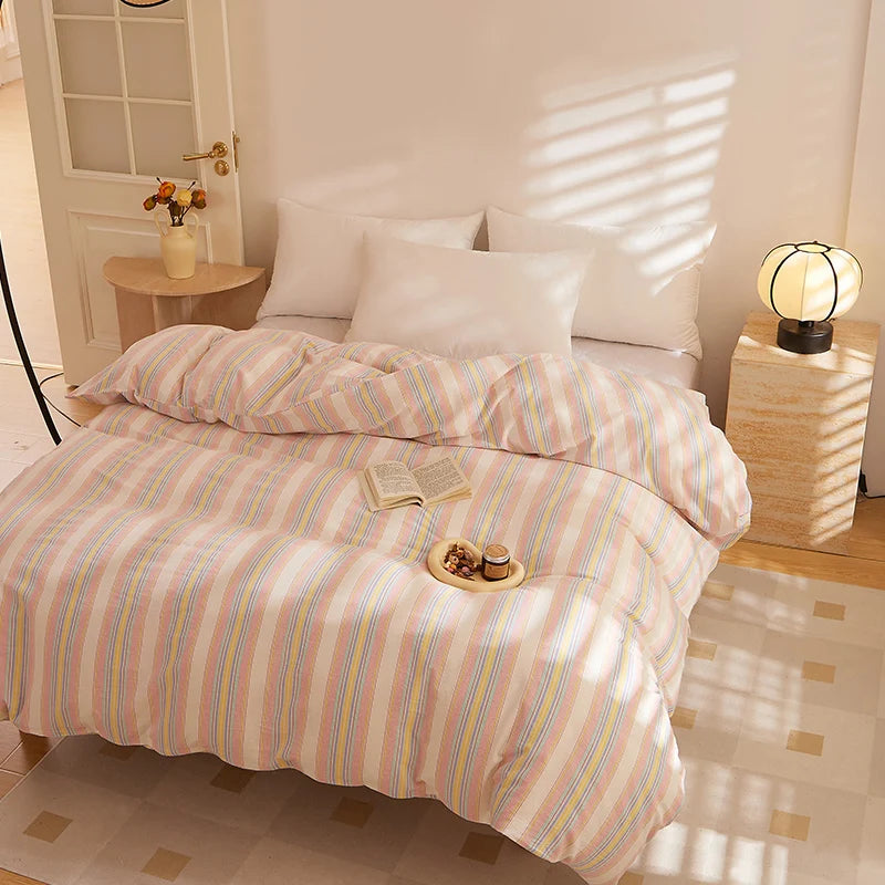 Soleil Stripe Bedding Set in Butter Stripe on a sunlit bed with a book and morning tea tray on top