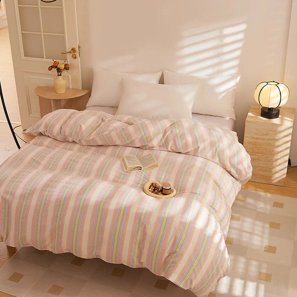 Soleil Stripe Bedding Set in Butter Stripe on a sunlit bed with a book and morning tea tray on top