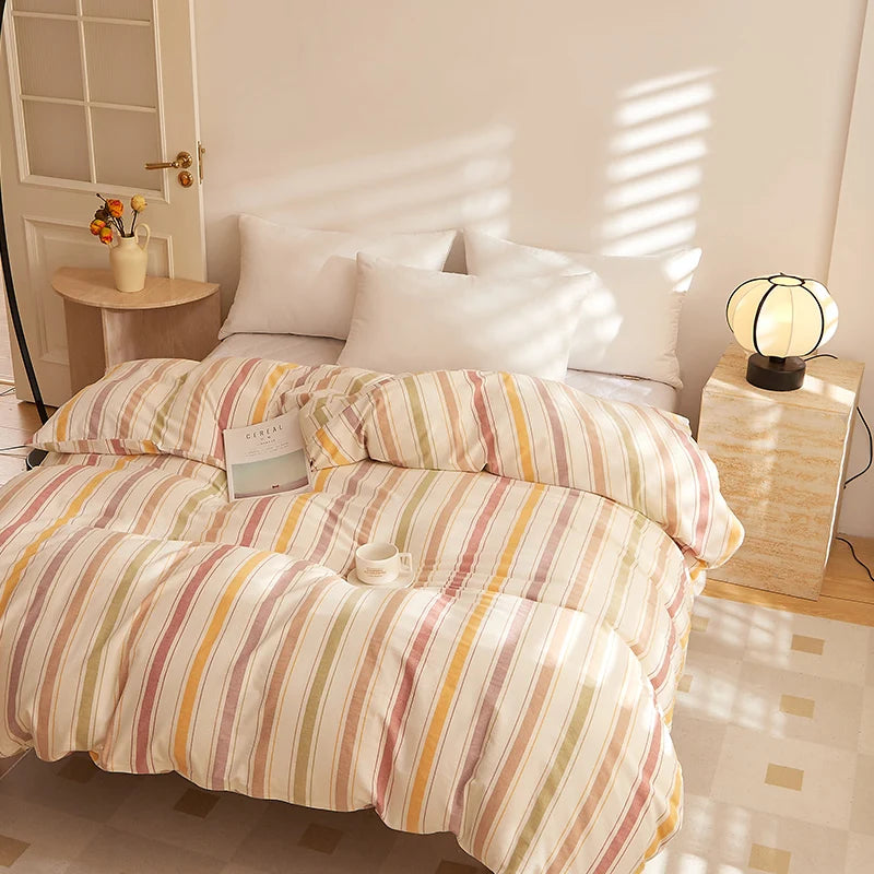 Soleil Stripe Bedding Set in Candy Foam, multicolour stripes on a sunlit made bed with white pillows