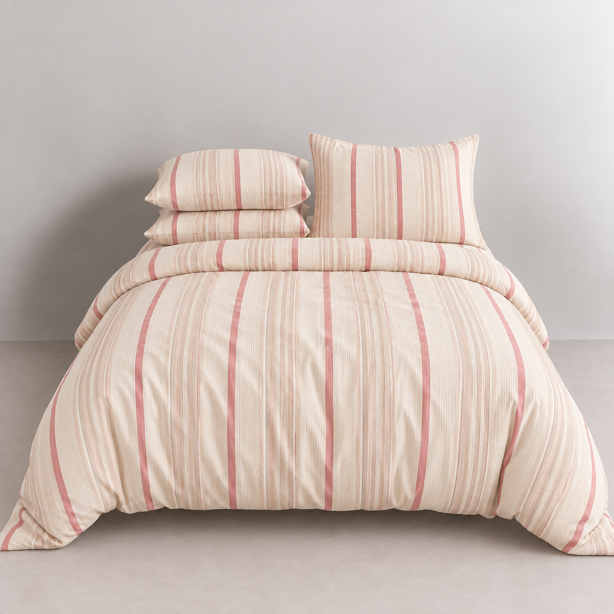 Soleil Stripe Bedding Set in Caramel Clay, made bed with pink and cream vertical stripes