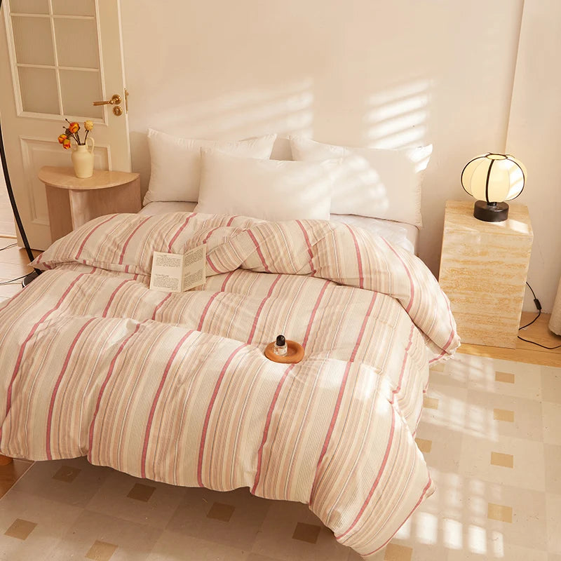 Soleil Stripe Bedding Set in Caramel Clay, striped quilt cover on a sunlit bed with white pillowcases