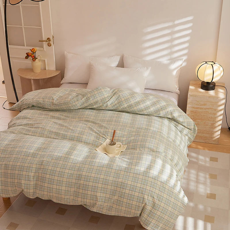 Soleil Stripe Bedding Set in Moss Horizon on a sunlit bed, soft green and yellow check-woven cotton with white pillowcases