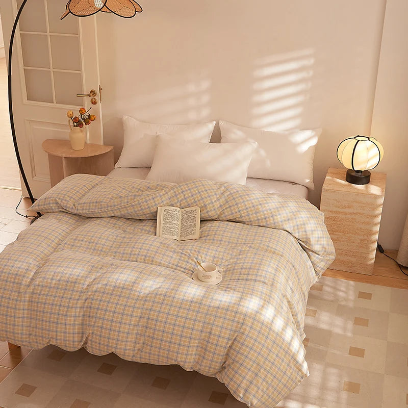 Soleil Stripe Bedding Set in Oat Milk, yellow-check quilt cover styled on a sunlit bed with a book and cup