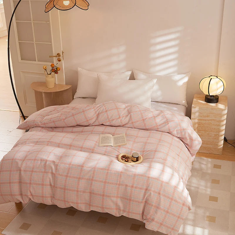 Soleil Stripe Bedding Set in Peach Dusk, soft pink check-weave quilt cover on a sunlit bed with white pillows