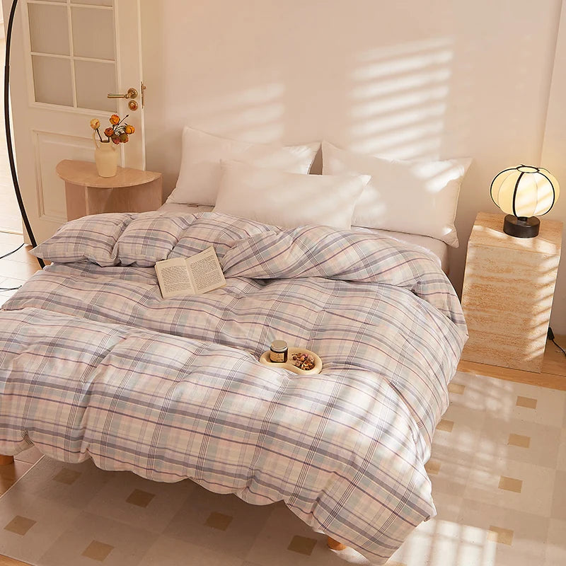 Soleil Stripe Bedding Set in soft pastel check on a sunlit bed, styled with a book and snack tray