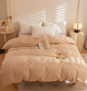 Soleil Stripe Bedding Set in soft yellow check on a sunlit bed, styled with a book and mug