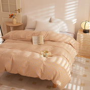 Soleil Stripe Bedding Set in Sunset Honey, warm check-woven quilt cover on a sunlit bed with book and mug