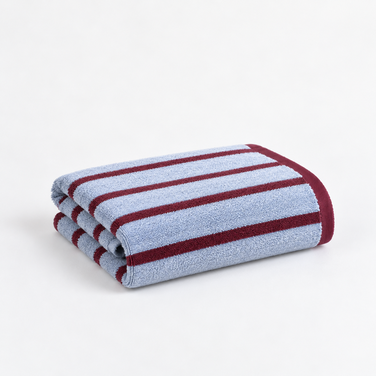 Folded Bath Towel from the Stay Soft™ Neutral Towel Collection in Blue, with contrast burgundy stripe detail