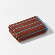 Stay Soft™ Neutral Towel Collection hand towel in Brown, folded with retro blue stripes and contrast edge