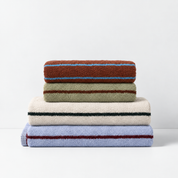 Stay Soft™ Neutral Towel Collection folded stack in brown, green, beige and blue, each with a contrast stripe