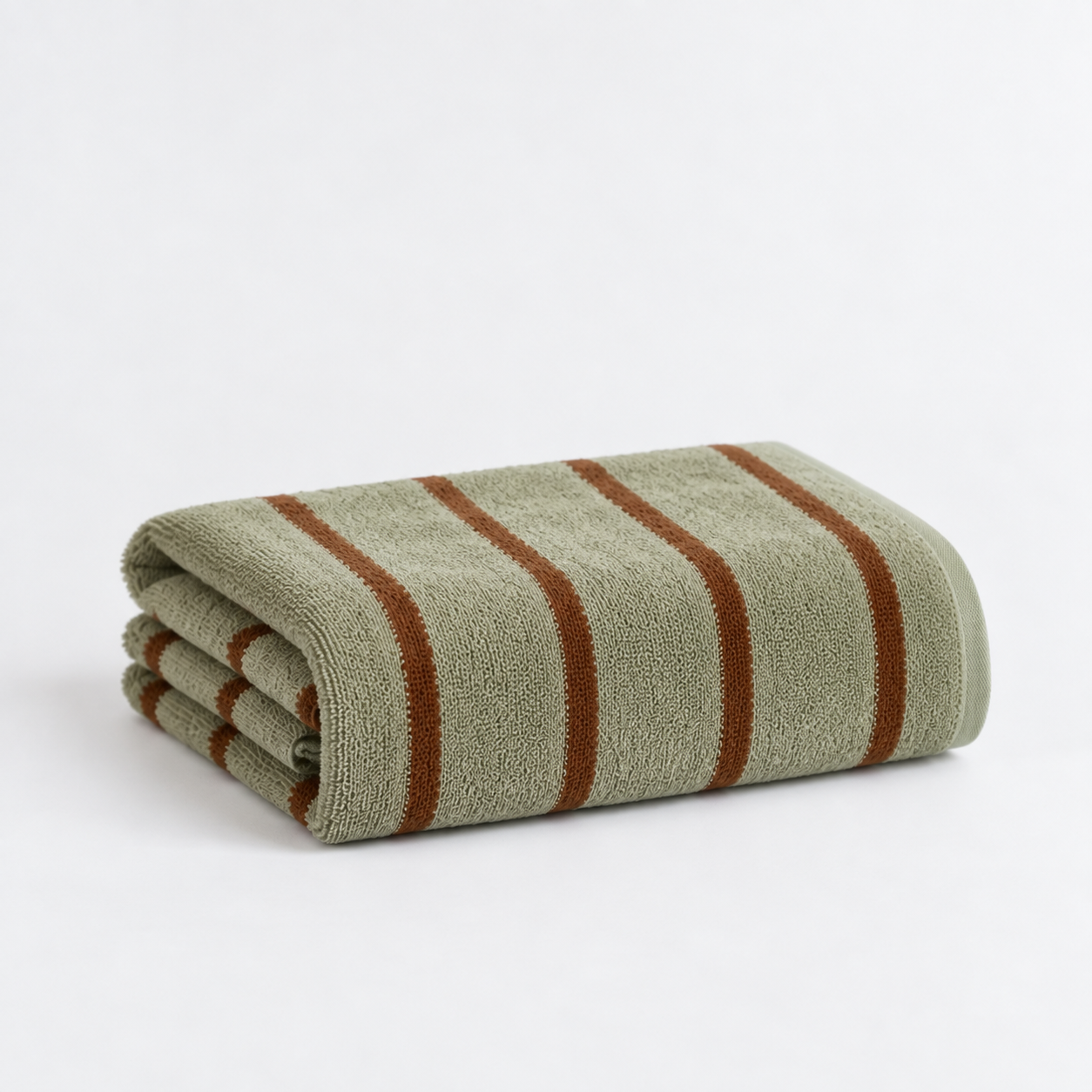 Folded bath towel from the Stay Soft™ Neutral Towel Collection in Green, with rust retro stripes on thick cotton pile