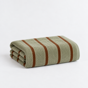 Folded bath towel from the Stay Soft™ Neutral Towel Collection in Green, with rust retro stripes on thick cotton pile