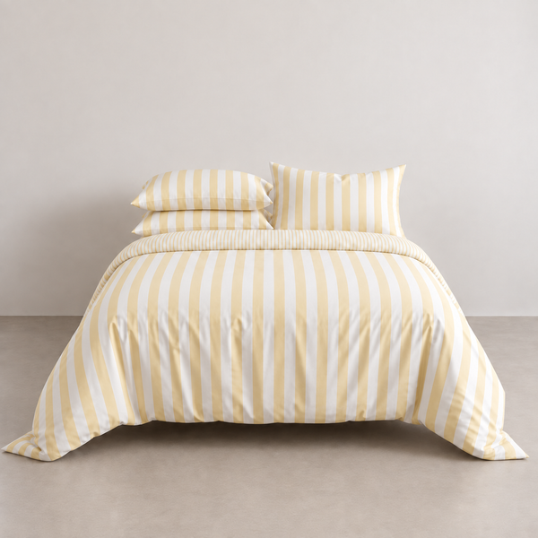 Striped Bedding Set in Yellow, bold cotton stripes on a made bed with matching pillowcases