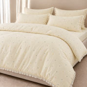 Sundae Spot Bedding Set in Custard Polka, made bed with multicolour dots and a frilled edge