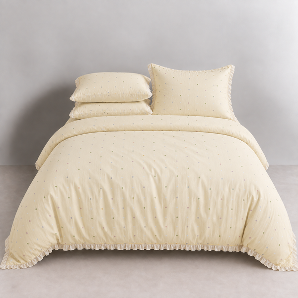 Sundae Spot Bedding Set in Custard Polka, made bed with scattered dots and a soft gathered frill
