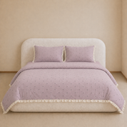 Sundae Spot Bedding Set in Lavender Polka on a made bed, with frilled edges and scattered dot print