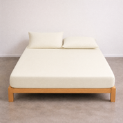 Tate Fitted Sheet in Beige, fitted smoothly over a mattress on a timber bed frame
