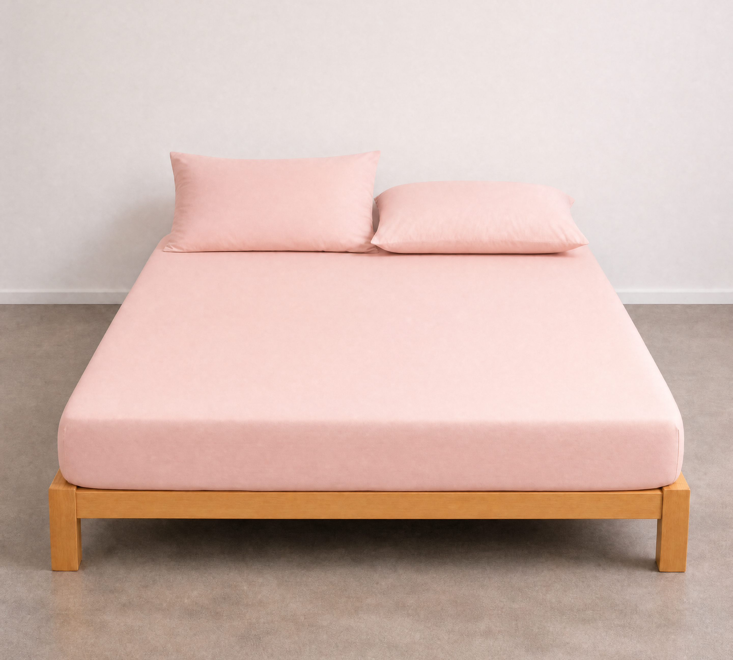 Tate Fitted Sheet in Light Pink dresses a timber bed frame, soft blush tone on a smooth twill weave