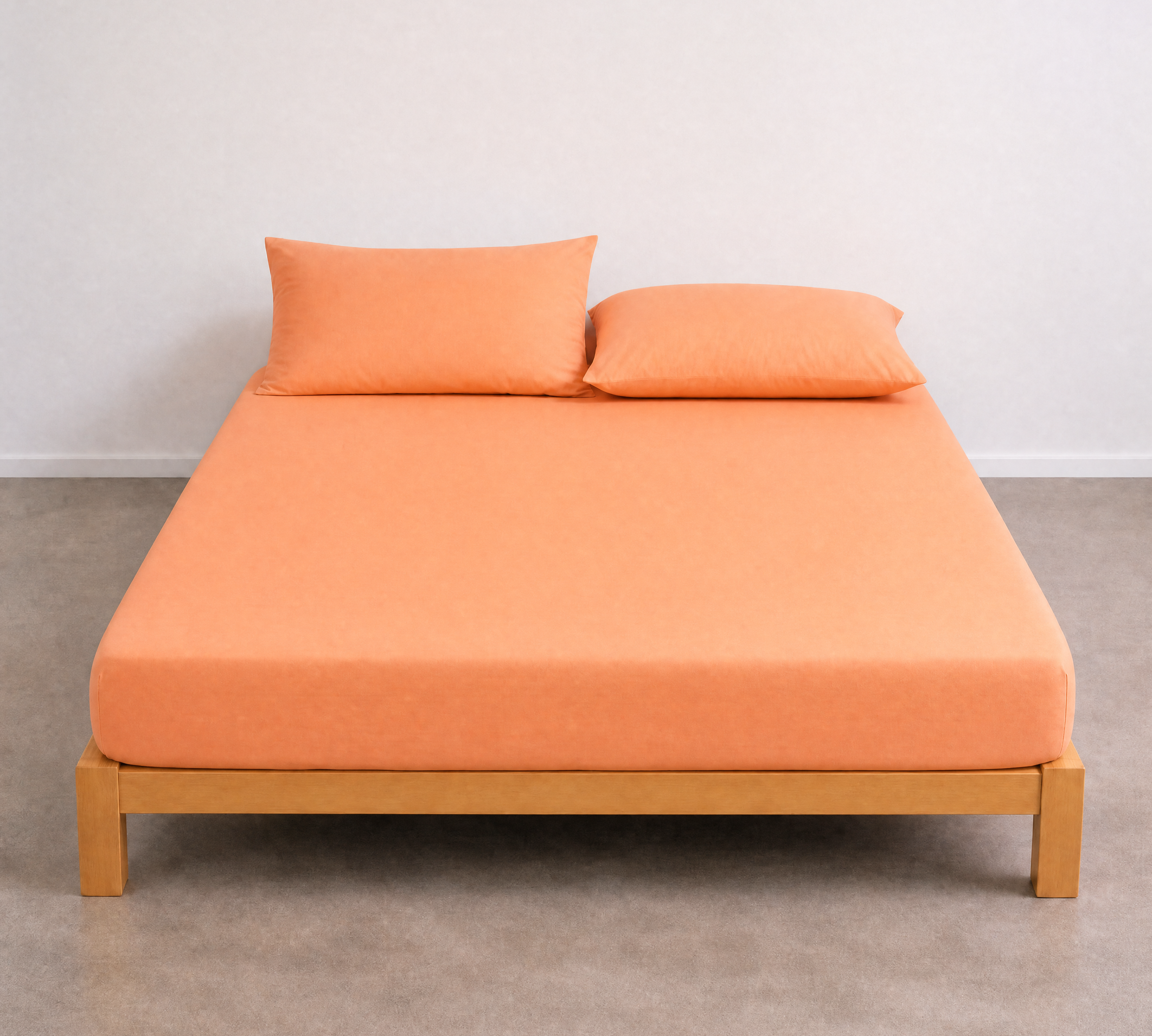 Tate Fitted Sheet in Orange, fitted snugly on a bare timber bed frame with matching pillowcases