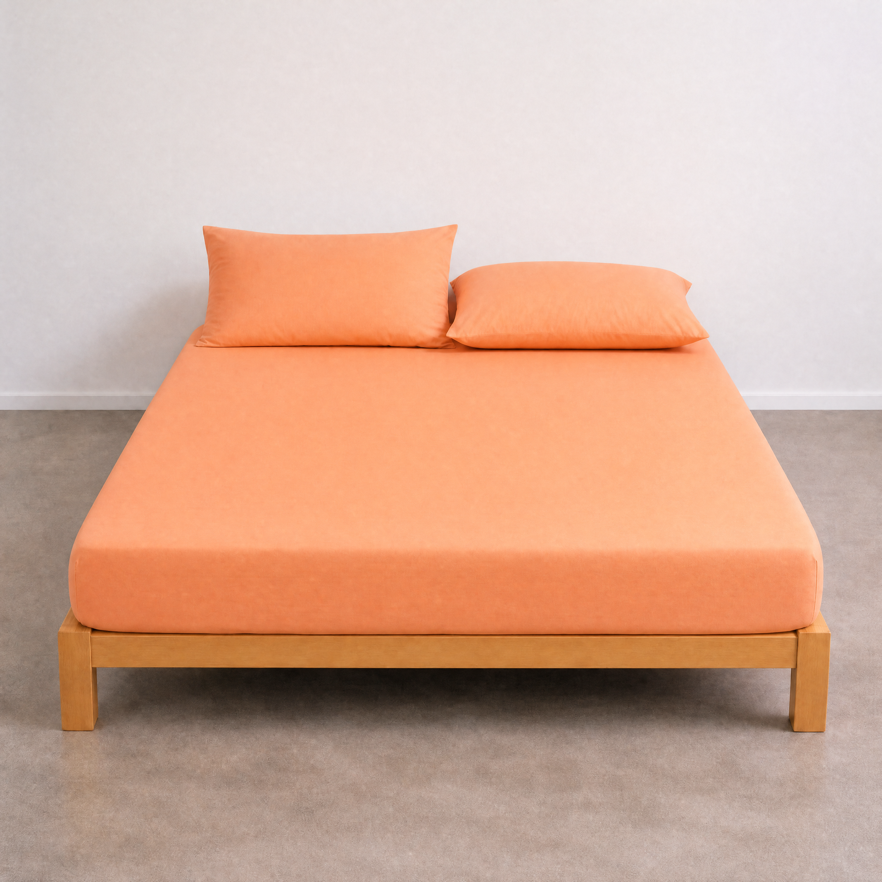 Tate Fitted Sheet in Orange, fitted snugly on a bare timber bed frame with matching pillowcases
