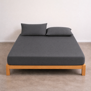 Tate Fitted Sheet in charcoal grey, fitted on a timber bed frame with matching pillowcases