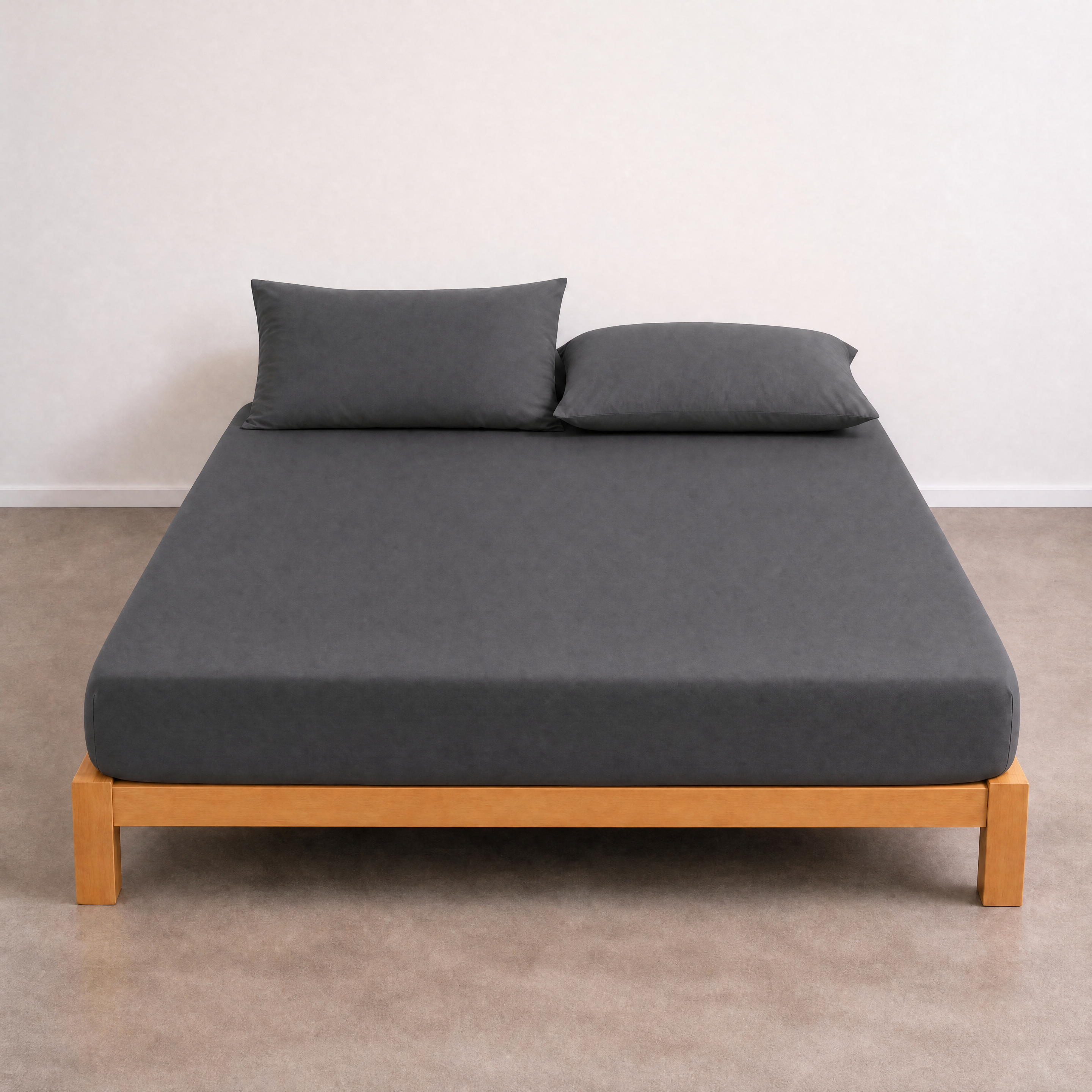Tate Fitted Sheet in charcoal grey, fitted on a timber bed frame with matching pillowcases