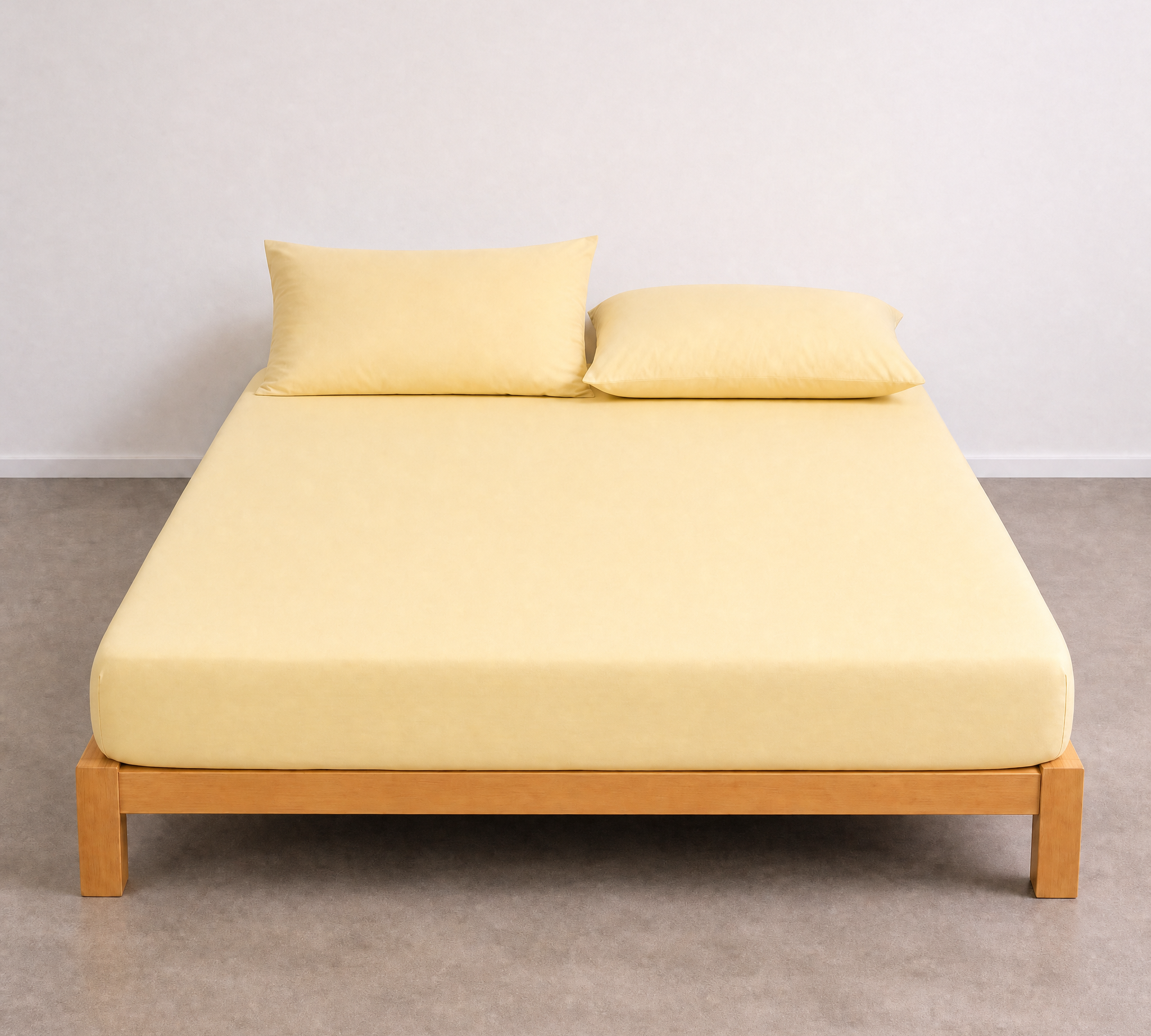 Tate Fitted Sheet in Yellow, fitted snugly over a mattress on a timber bed frame