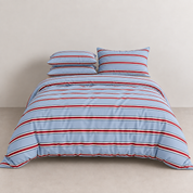 Vida Bedding Set in Blue & Red, striped quilt cover and pillowcases on a made bed against a plain wall