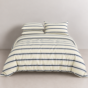 Vida Bedding Set in Cream & Blue, navy striped quilt cover and pillowcases on a made bed